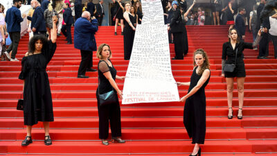 Feministas muestran en alfombra roja de Cannes pancarta con nombres de 129 mujeres asesinadas