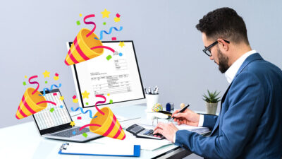 Día del contador: Hombre frente a una computadora revisando una factura y adornos de fiesta